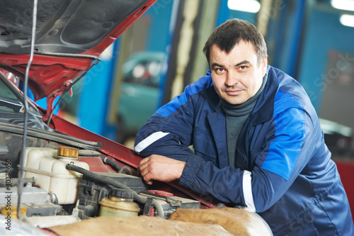 Photo: happy mechanic technician at service station happy mechanic technician at service station