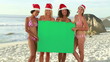 A group of women holding a green board