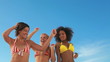Three dancing friends in their bikinis