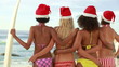 Video: Four women standing while wearing Christmas hats Four women standing while wearing Christmas hats