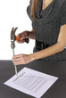 Foto: Metaphor businesswoman nails contract agreement Metaphor businesswoman nails contract agreement