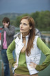 Young woman annoyed with boyfriend using mobile phone