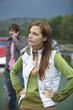 Young woman annoyed with boyfriend using mobile phone