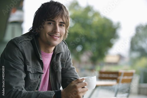 Photo: Young man drinking tea, portrait Young man drinking tea, portrait