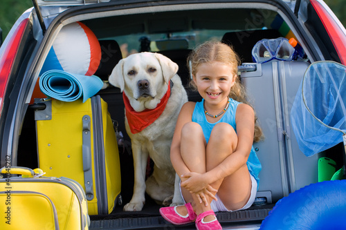Photo: Travel, lovely girl with dog ready for family travel Travel, lovely girl with dog ready for family travel