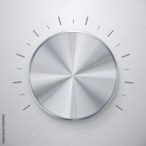 Photo: Shiny silver volume knob over brushed metal background Shiny silver volume knob over brushed metal background