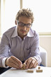 Mid adult man arranging wooden blocks