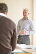 Photo: Businessmen discussing in office Businessmen discussing in office