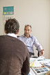 Photo: Businessmen discussing in office Businessmen discussing in office