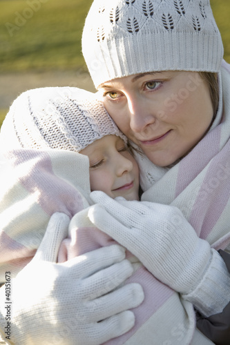 Photo: Mother hugging daughter, close-up Mother hugging daughter, close-up
