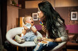 Foto: Smiling baby playing with his mum Smiling baby playing with his mum