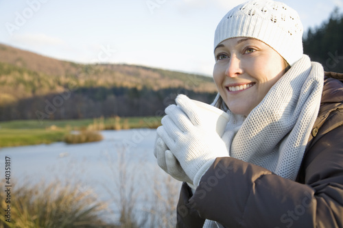 Photo: Mid adult woman holding teacup Mid adult woman holding teacup