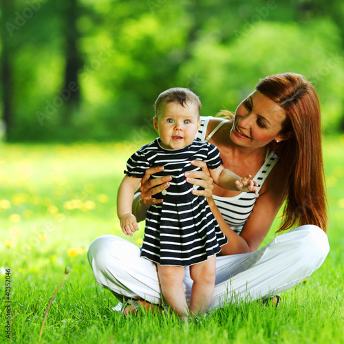Photo: Mother and daughter on the green grass Mother and daughter on the green grass