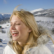 Young woman smiling, side view
