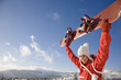 Young woman holding snowboard, smiling, portrait