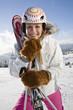 Young woman holding ski pole, portrait