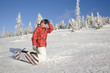 Young man kneeling on snow