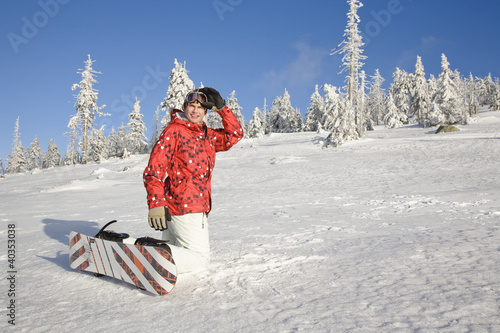 Photo: Young man kneeling on snow Young man kneeling on snow