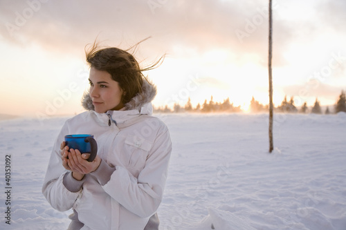 Photo: Young woman holding mug, smiling Young woman holding mug, smiling