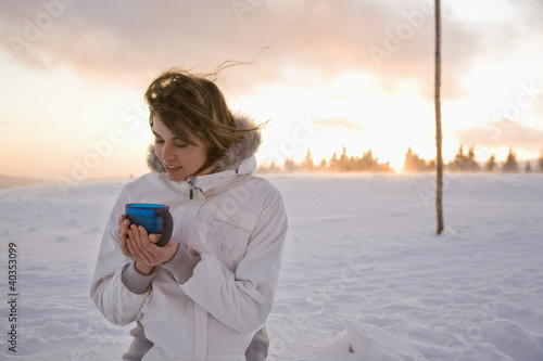 Photo: Young woman holding mug, smiling Young woman holding mug, smiling