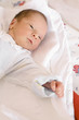 Baby in bed with red spots on face