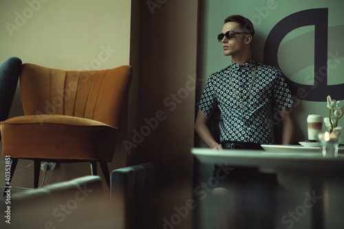 Photo: Elegant young man sitting in a bar Elegant young man sitting in a bar