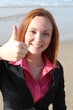 Thumbs up! - beautiful woman at the beach gesturing thumbs up