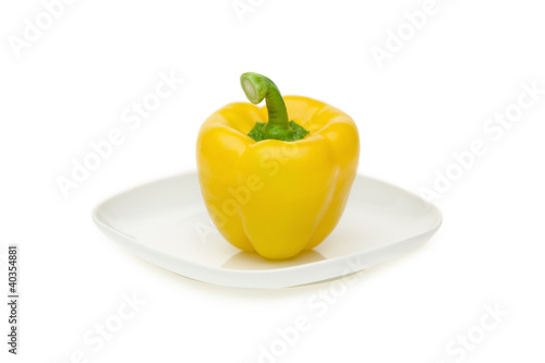 Photo: Yellow bell pepper on plate, close-up Yellow bell pepper on plate, close-up