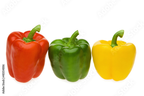 Photo: Red, green and yellow pepper on white background, close-up Red, green and yellow pepper on white background, close-up