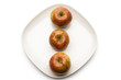 Three apples on plate, directly above