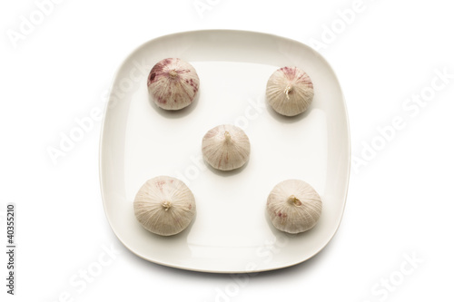 Photo: Garlic on plate, directly above Garlic on plate, directly above
