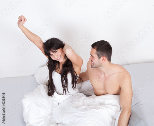Photo: Couple waking up in bed Couple waking up in bed