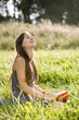 Mid adult woman holding book on field