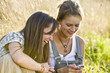 Mid adult women looking at mobile phone, smiling