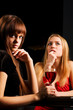 Two young women in a night bar