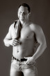 Photo: Adult muscular man, on the grey background Adult muscular man, on the grey background