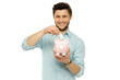 Man putting money in piggy bank