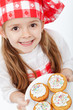 Happy little chef proud of her muffins