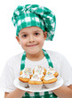 Happy chef boy with a plate of muffins