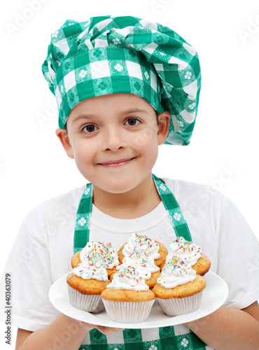 Photo: Happy chef boy with a plate of muffins Happy chef boy with a plate of muffins