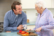 Mother and adult son preparing meal together