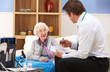 UK GP visiting senior woman at home
