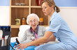 UK nurse visiting senior woman at home