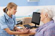 UK nurse injecting senior woman patient
