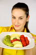 brunette female model showing fresh fruit on a plate brunette female model showing fresh fruit on a plate