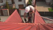 Painting roof of a private house with safety rope