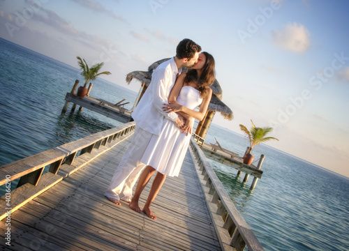 Photo: Sensual happy lovers in white clothes on the beach (Maldives) Sensual happy lovers in white clothes on the beach (Maldives)