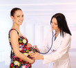 A female doctor with a stethoscope listening