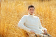 Autumn winter man portrait in outdoor dried grass
