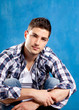 handsome young man with plaid shirt on blue handsome young man with plaid shirt on blue